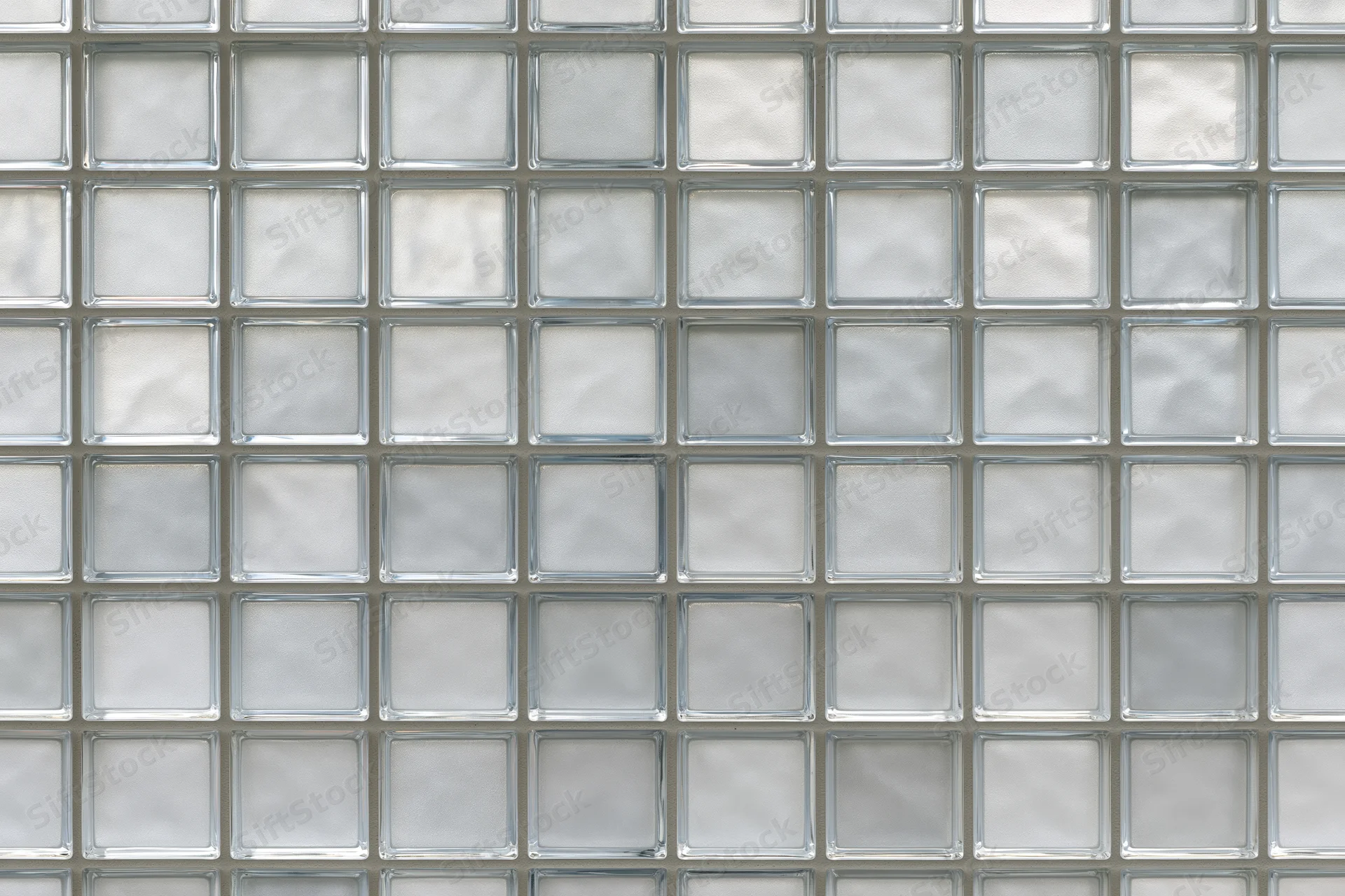 Grid of frosted glass blocks arranged in a uniform pattern on a wall