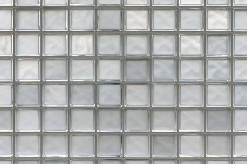 Grid of frosted glass blocks arranged in a uniform pattern on a wall