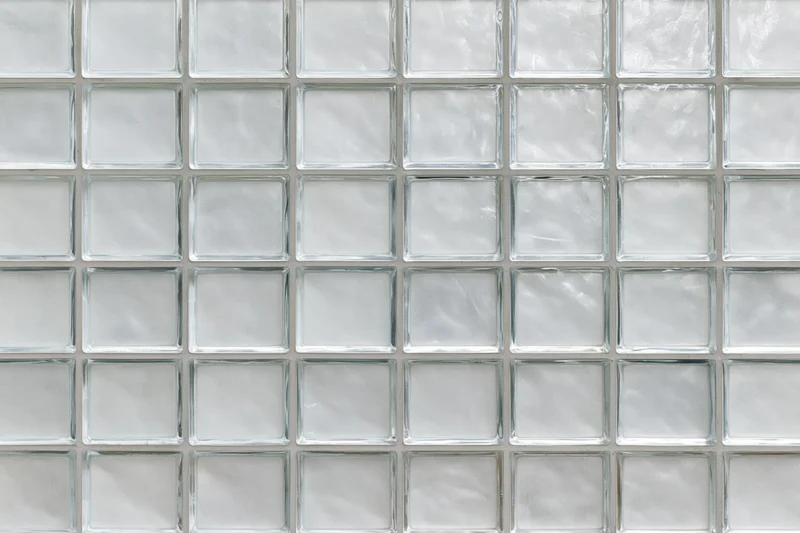 Grid of frosted glass panels arranged in a uniform pattern on a wall