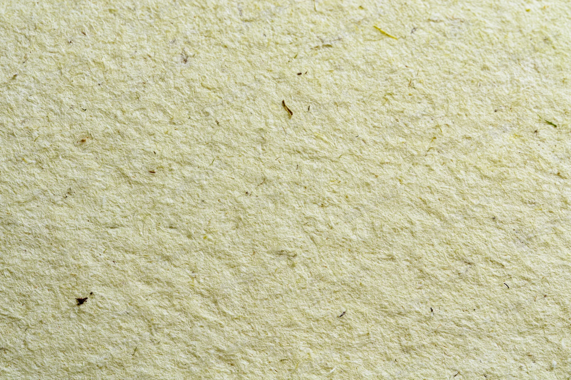 Close-up of handmade recycled paper with visible fibers and natural texture