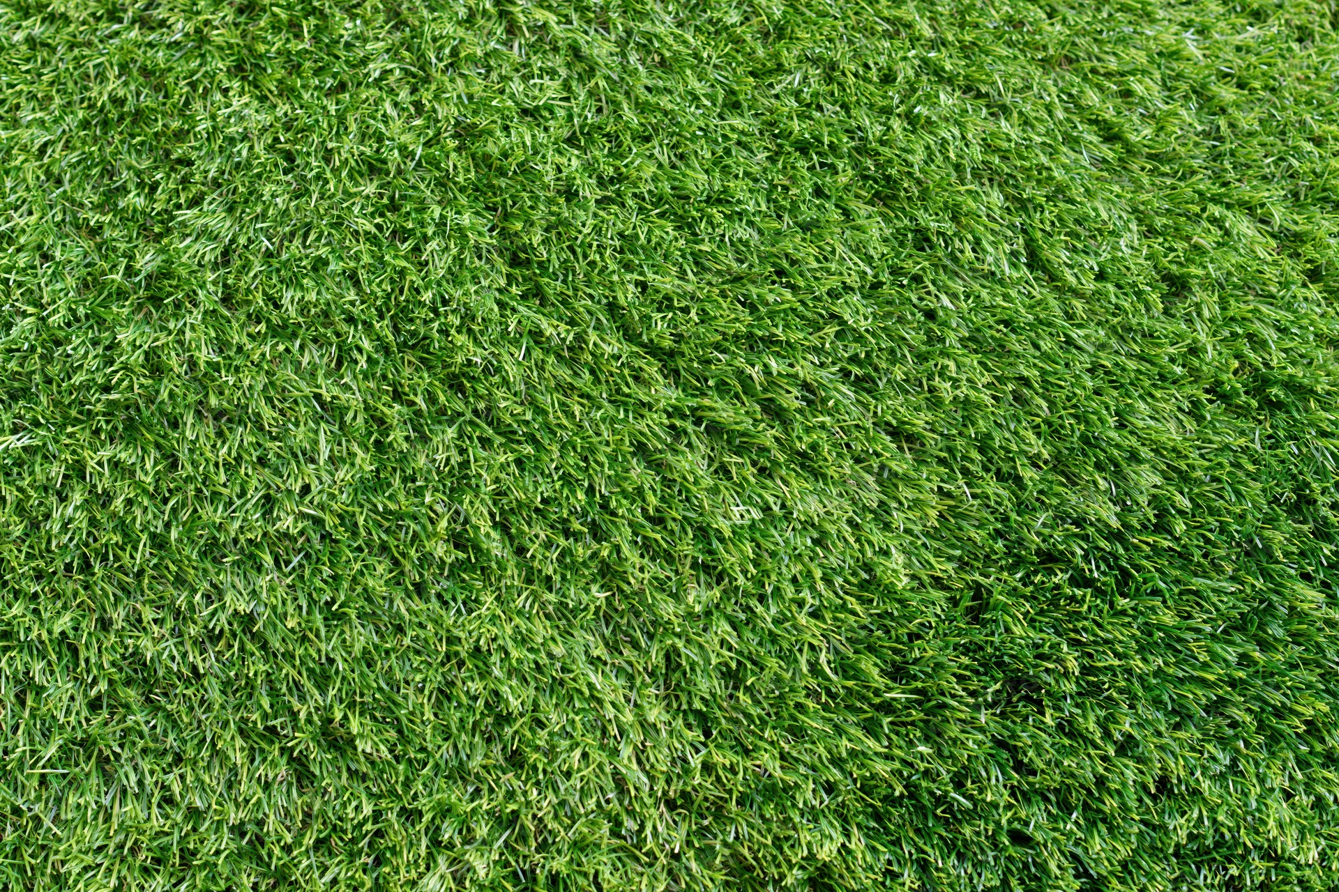 Close-up overhead view of short-cut artificial turf filling the frame