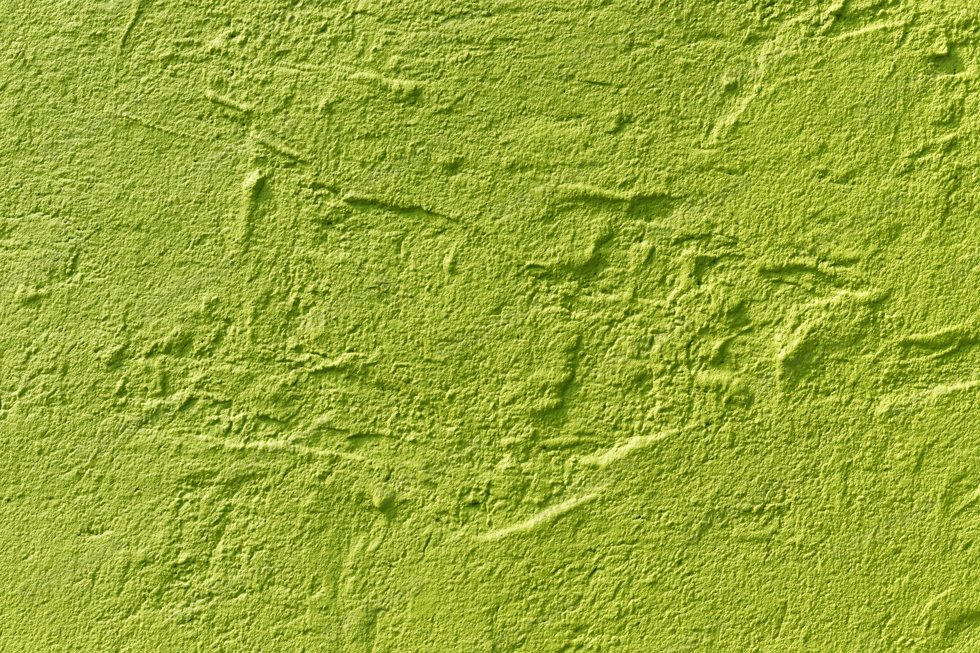Textured stucco wall painted bright grass green filling the frame