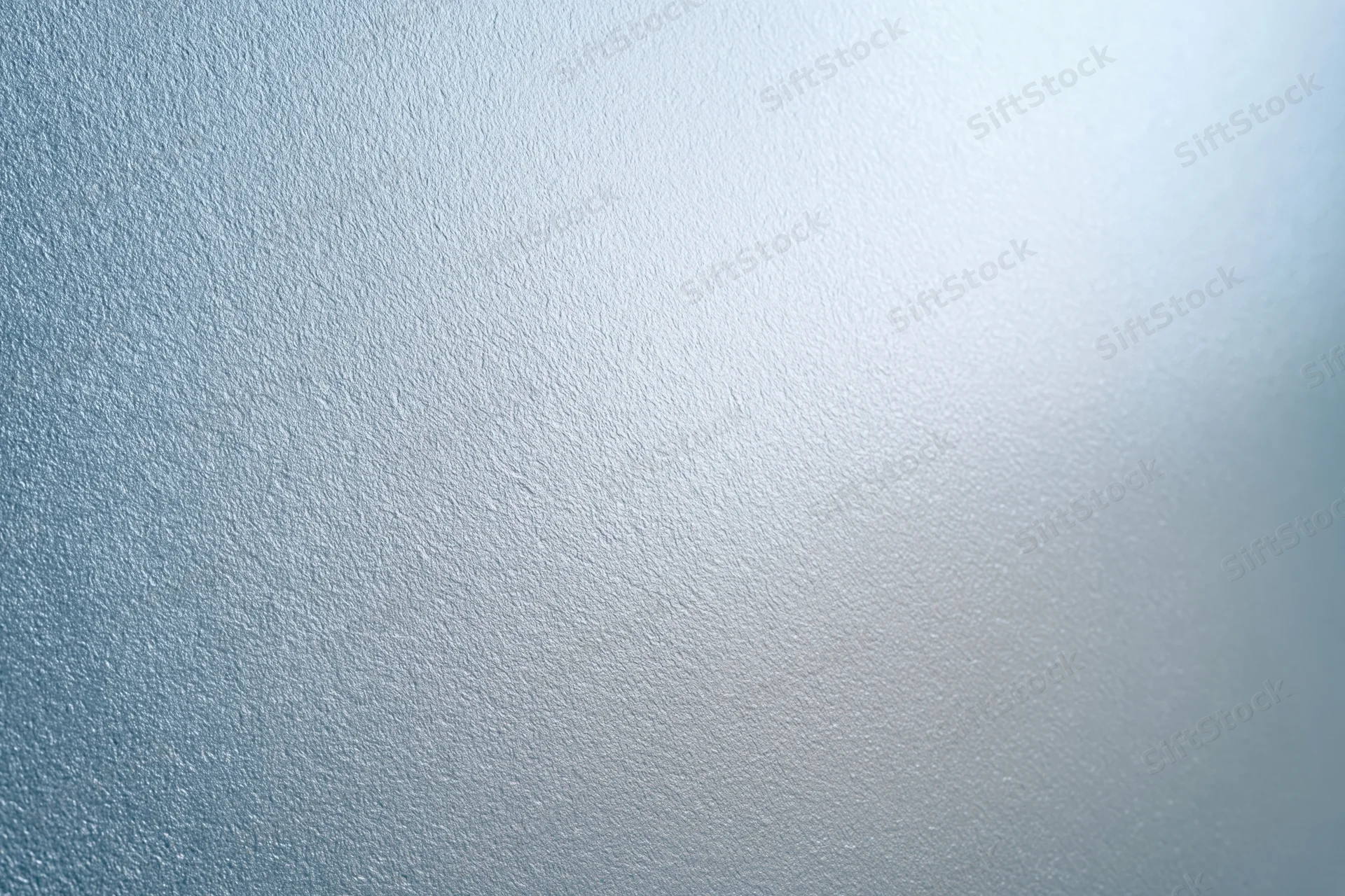 Frosted glass surface filling the frame with a smooth translucent texture and soft light gradient