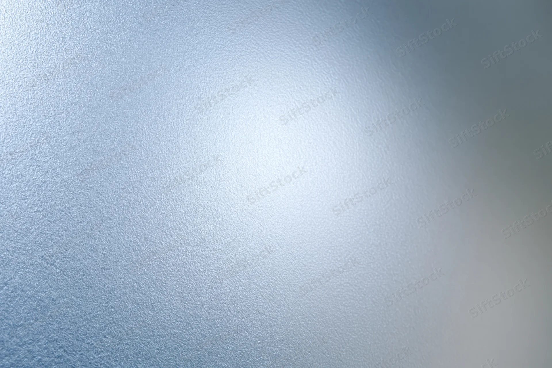 Frosted glass surface filling the frame with a smooth translucent texture and soft light gradient