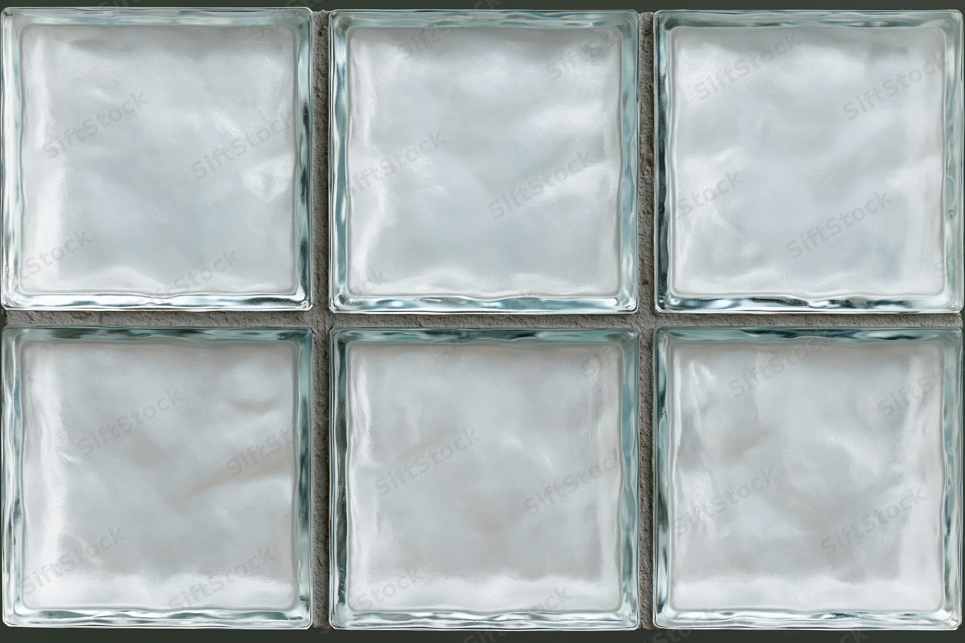 Grid of frosted glass block tiles arranged in three rows on a wall