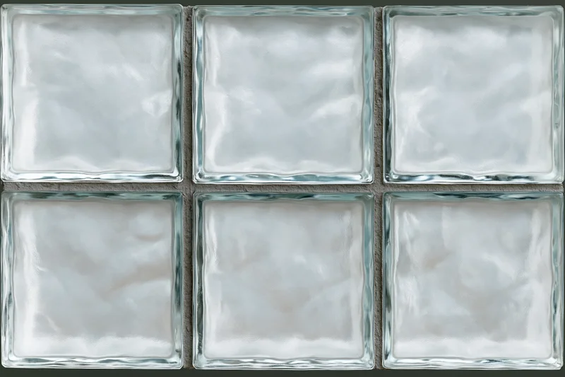Grid of frosted glass block tiles arranged in three rows on a wall