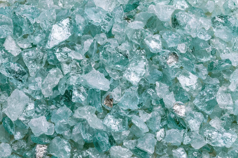 Crushed tempered glass fragments filling the frame in a dense, irregular pattern