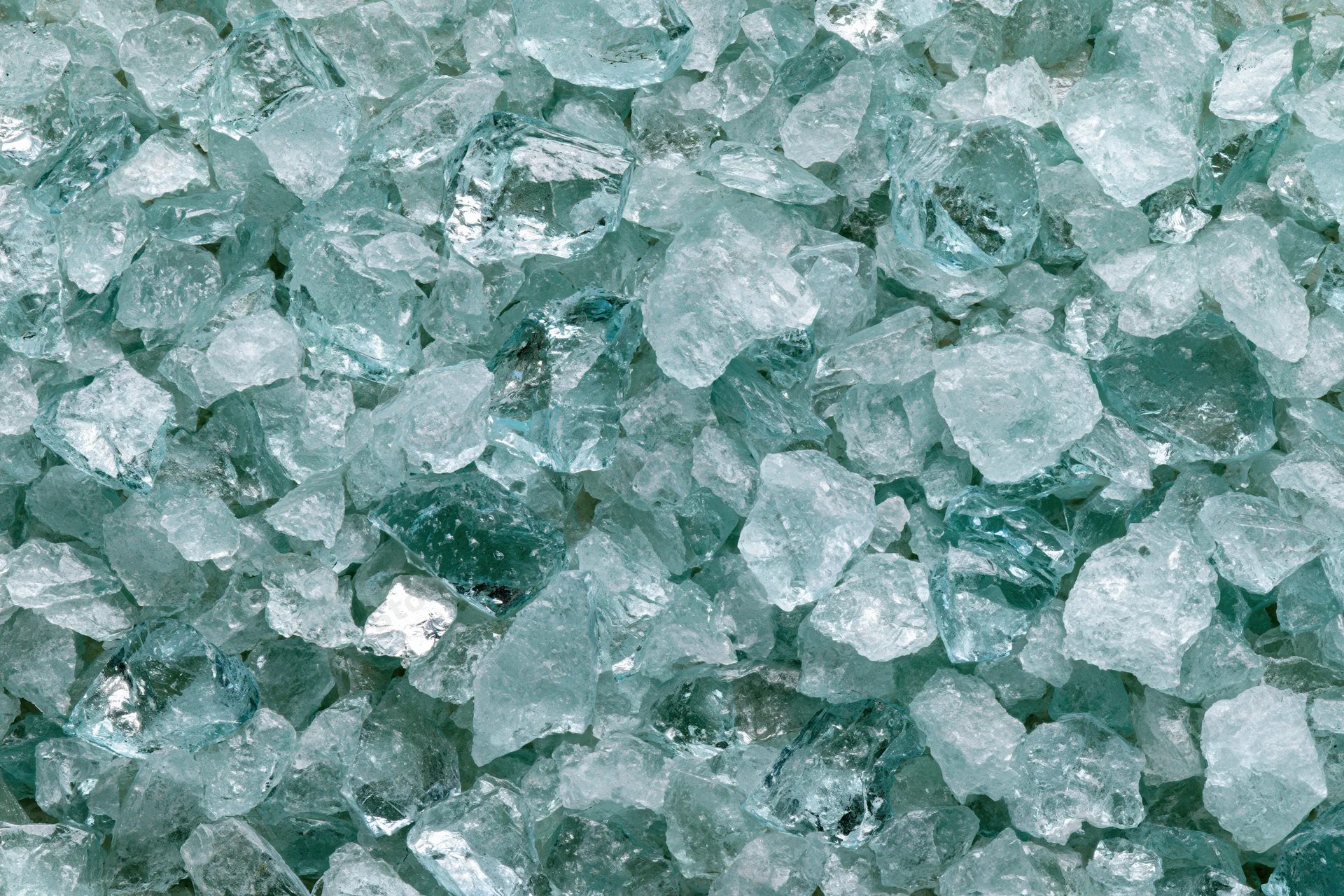 Crushed tempered glass fragments densely packed in a pile
