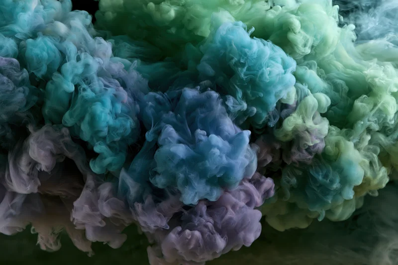 Ink dissolving in water forming swirling cloud formations