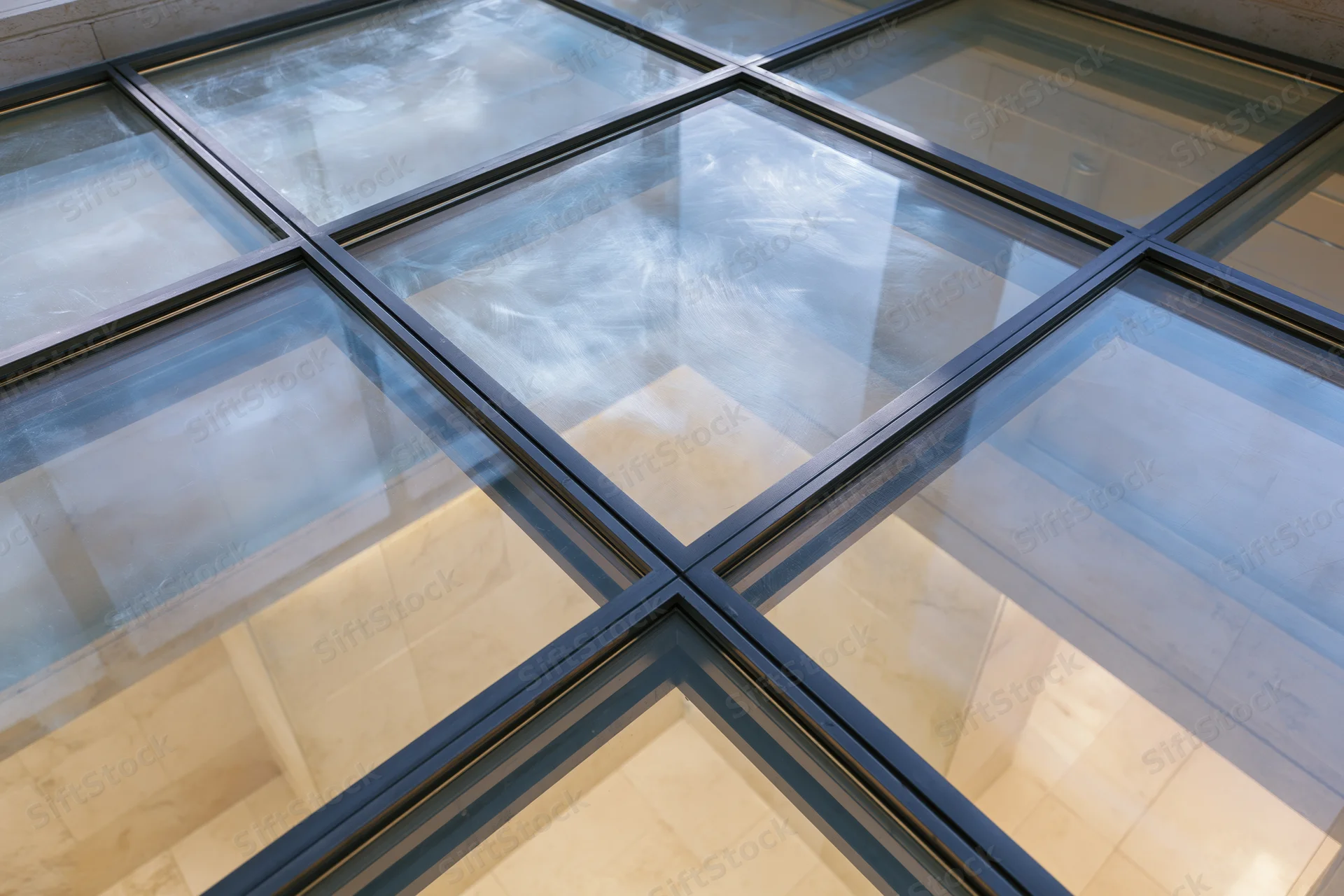 Structural glass floor panel viewed from above in a modern interior space