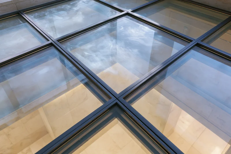 Structural glass floor panel viewed from above in a modern interior space