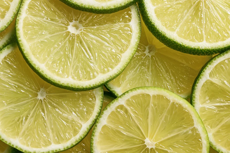 Lime slices arranged in a flat-lay pattern filling the frame