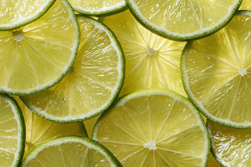 Lime slices arranged in a flat-lay pattern filling the frame