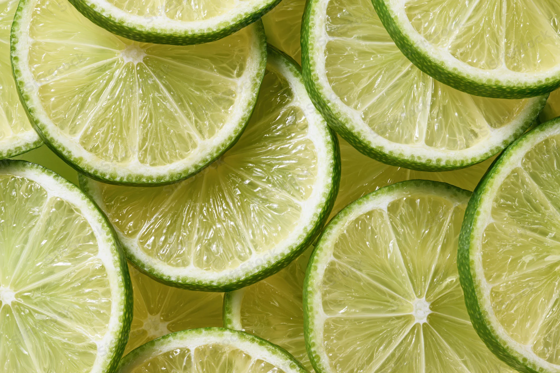 Lime slices arranged in a flat-lay pattern filling the frame
