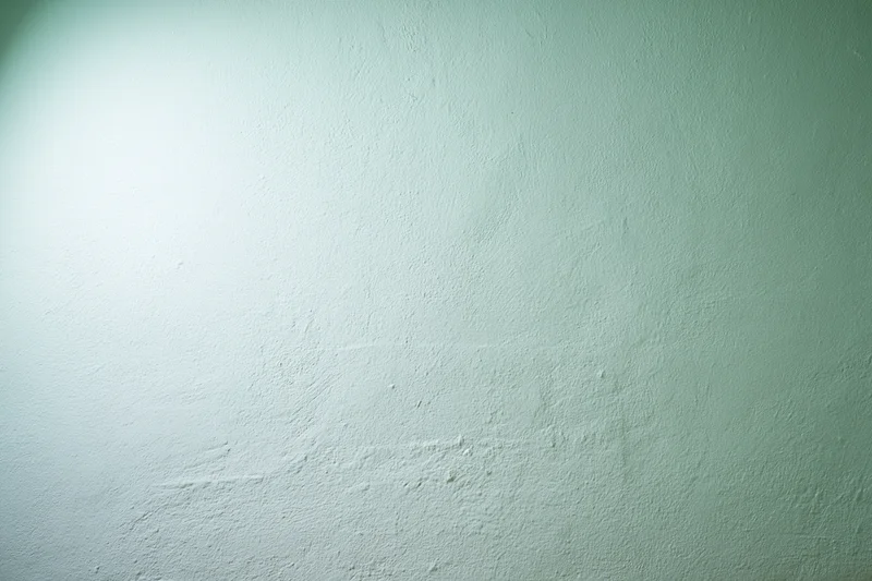 Plain painted wall surface filling the frame in a flat closeup view