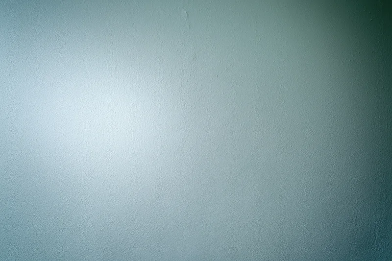 Plain painted wall surface filling the frame with even lighting and subtle texture