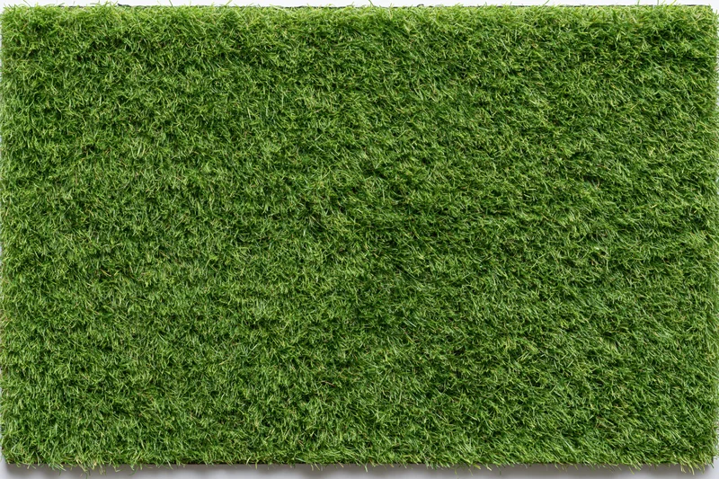 Rectangular patch of short mowed grass viewed from above on a flat surface