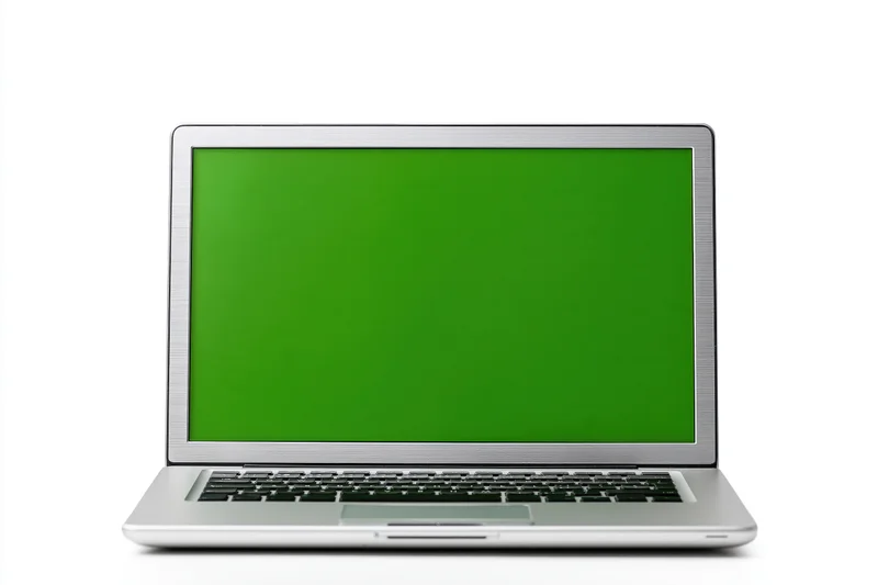 Silver aluminum laptop open facing forward with green screen display on white background