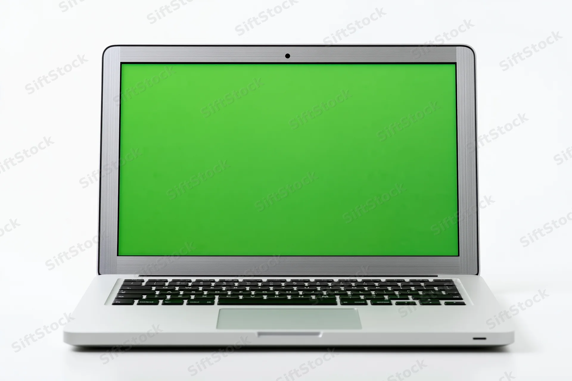 Silver aluminum laptop open facing forward with green screen display on white background