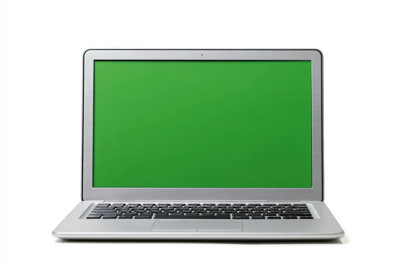 Silver aluminum laptop open facing forward with green screen display on white background
