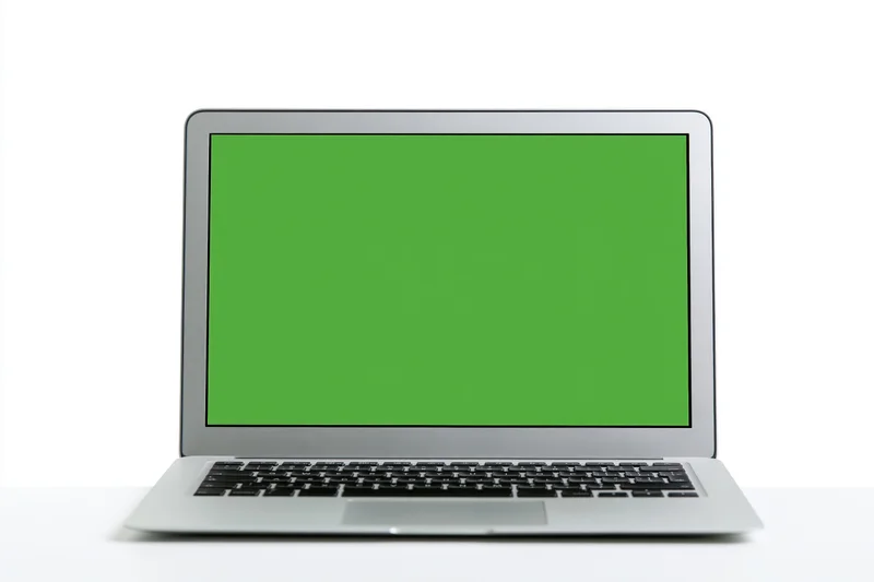 Silver aluminum laptop open facing forward with green screen display on white background