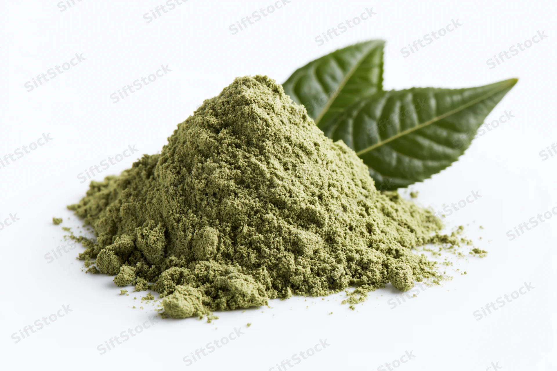 Small mound of matcha green tea powder with two fresh tea leaves on white background