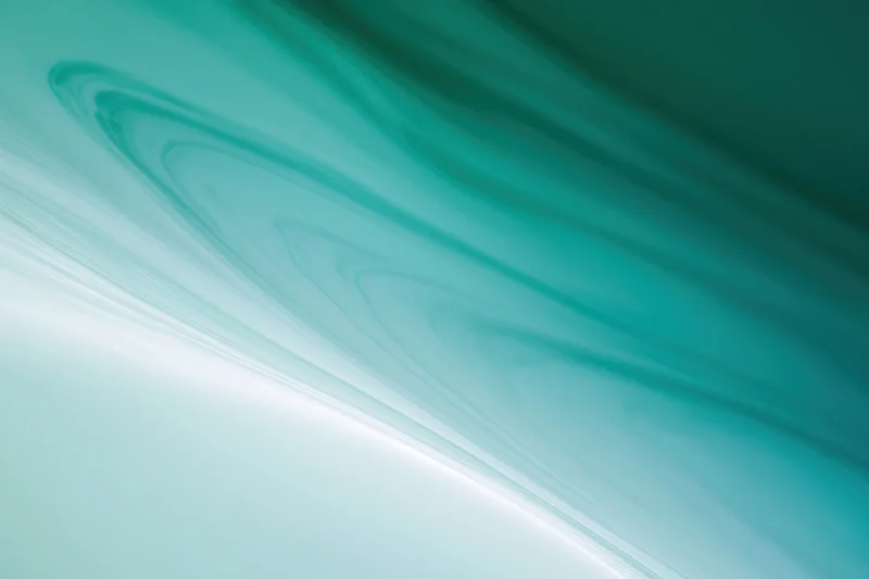 Smooth abstract gradient background transitioning from pale teal to white with flowing wave patterns