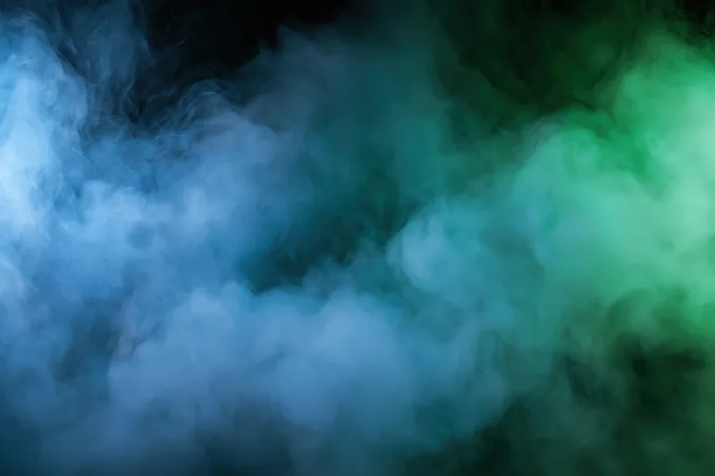Thick billowing smoke filling the frame in abstract blue and green hues