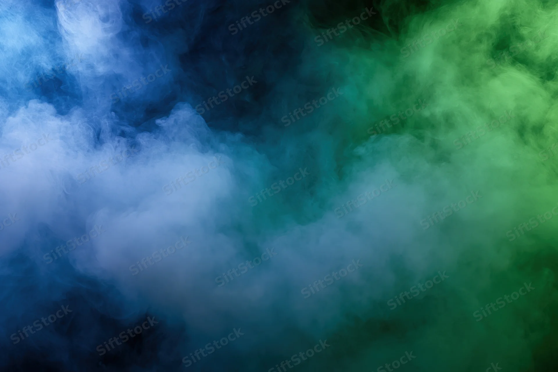 Thick billowing smoke in blue and green hues filling the frame as an abstract texture
