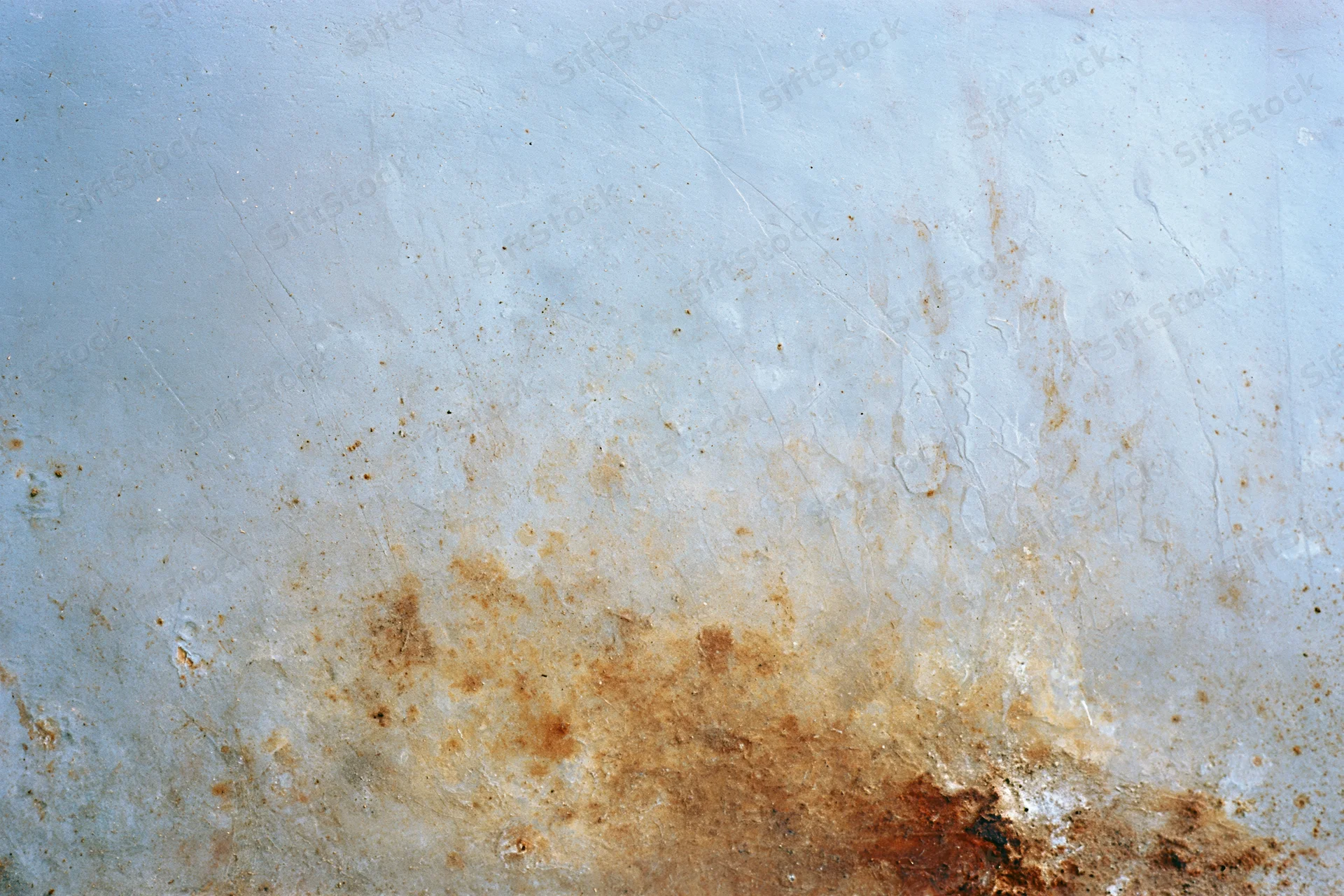 Weathered metal surface with rust and peeling paint showing signs of corrosion and decay