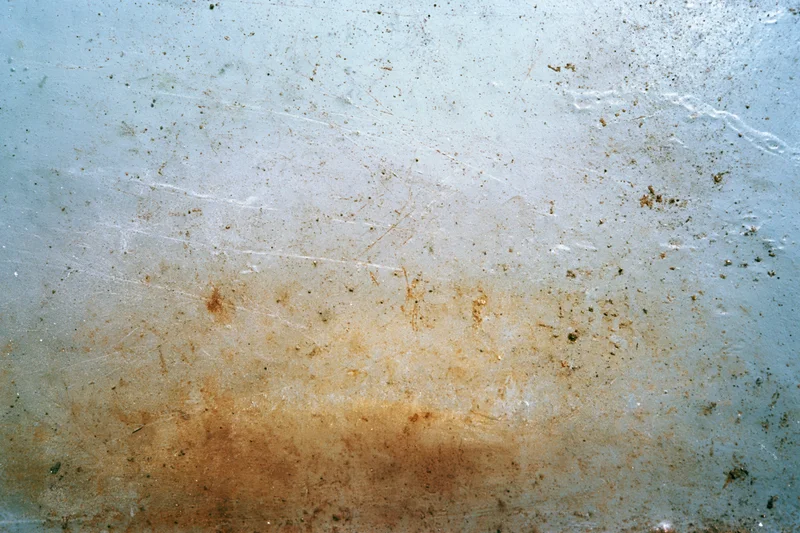 Weathered metal surface with rust and scratches in flat lay closeup