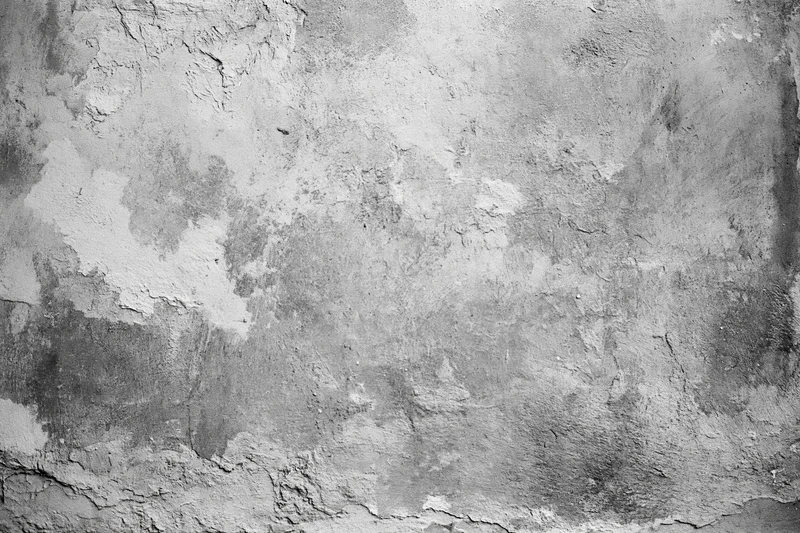 Weathered concrete wall surface filling the frame with cracks and peeling paint