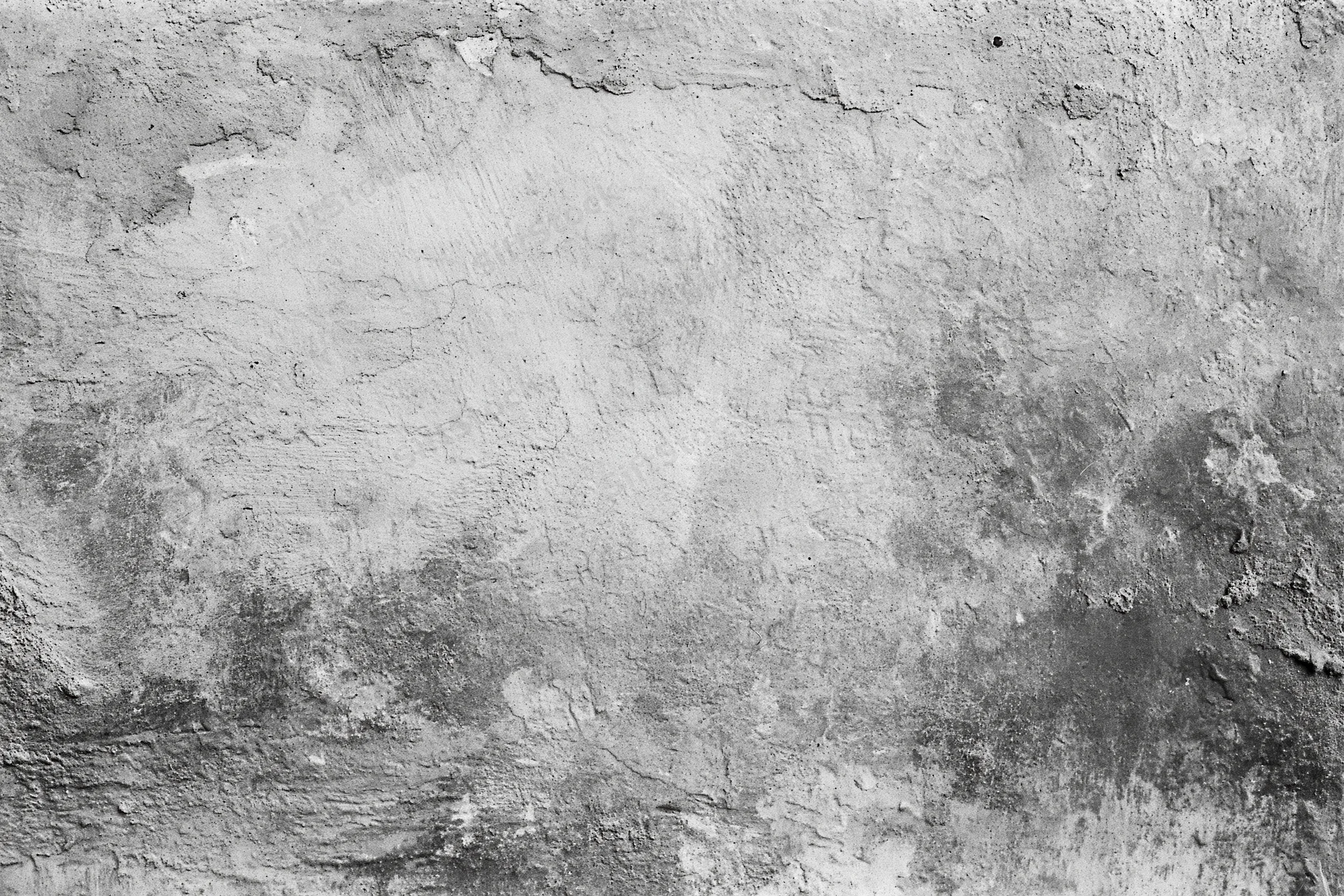 Weathered concrete wall surface filling the frame with cracks and peeling texture
