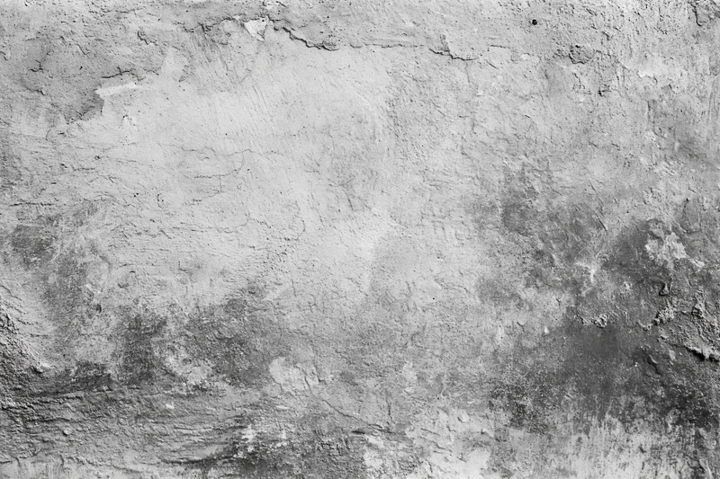 Weathered concrete wall surface filling the frame with cracks and peeling texture