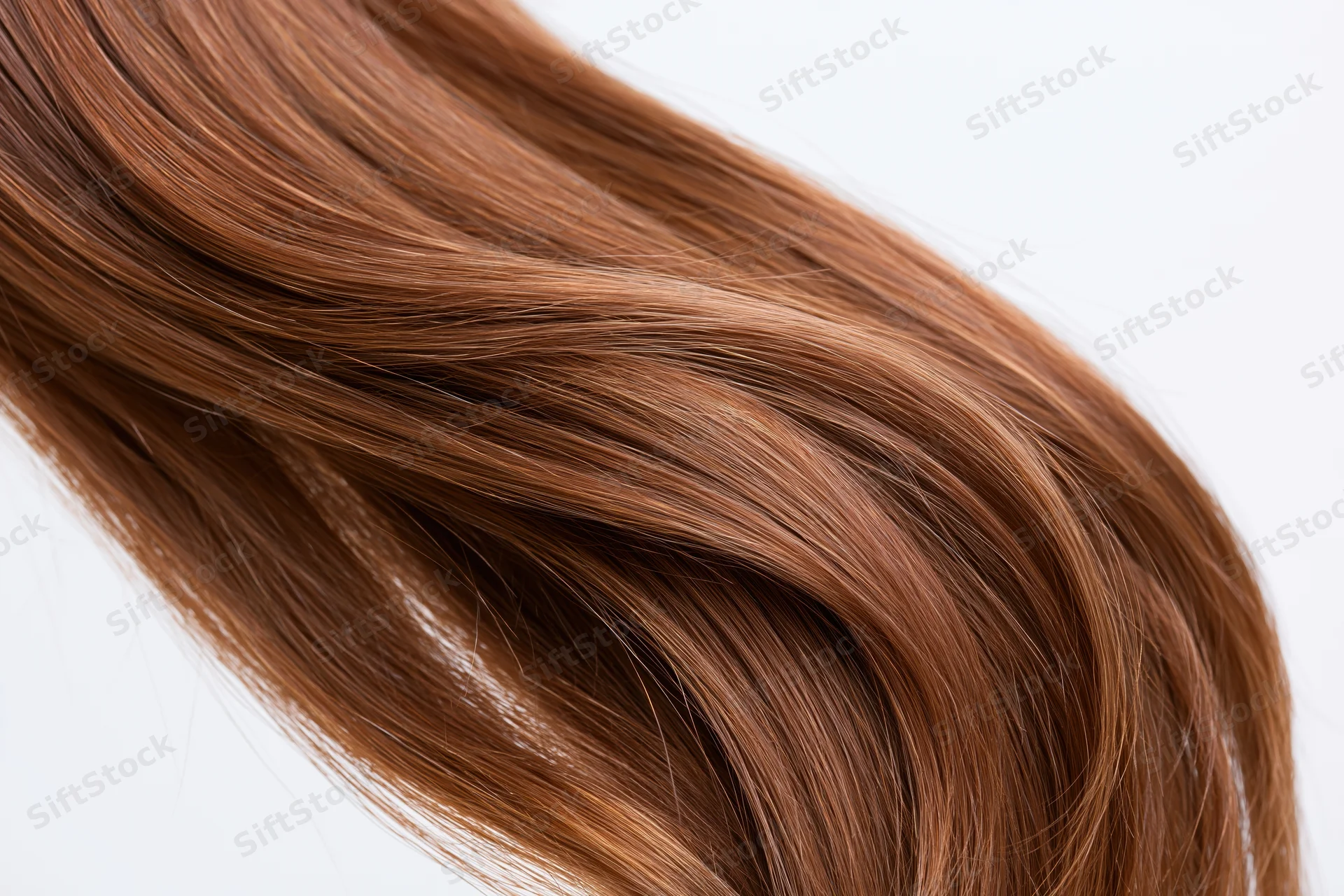 Flowing auburn-brown hair in motion against a white background