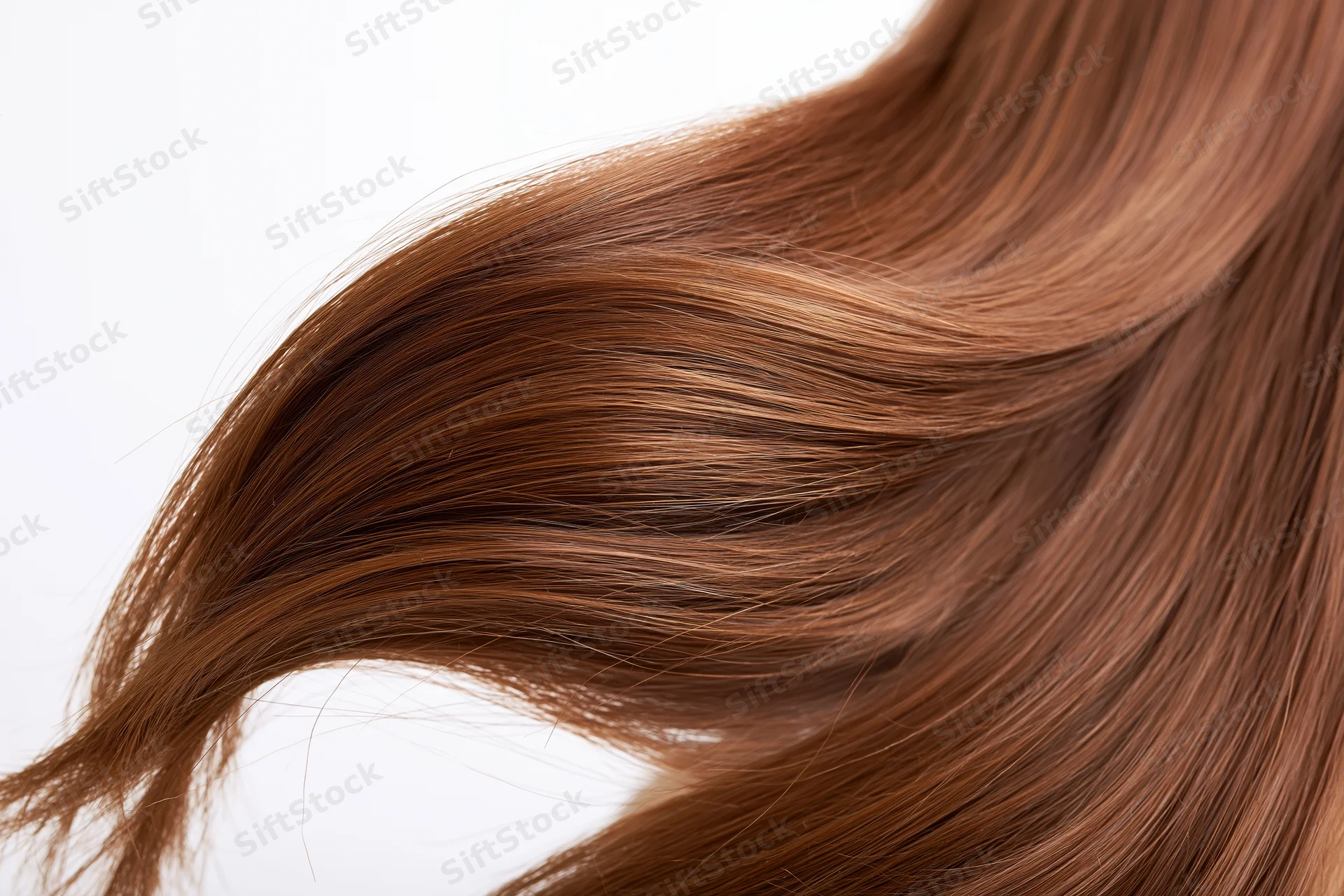 Flowing auburn-brown hair in motion against a white background