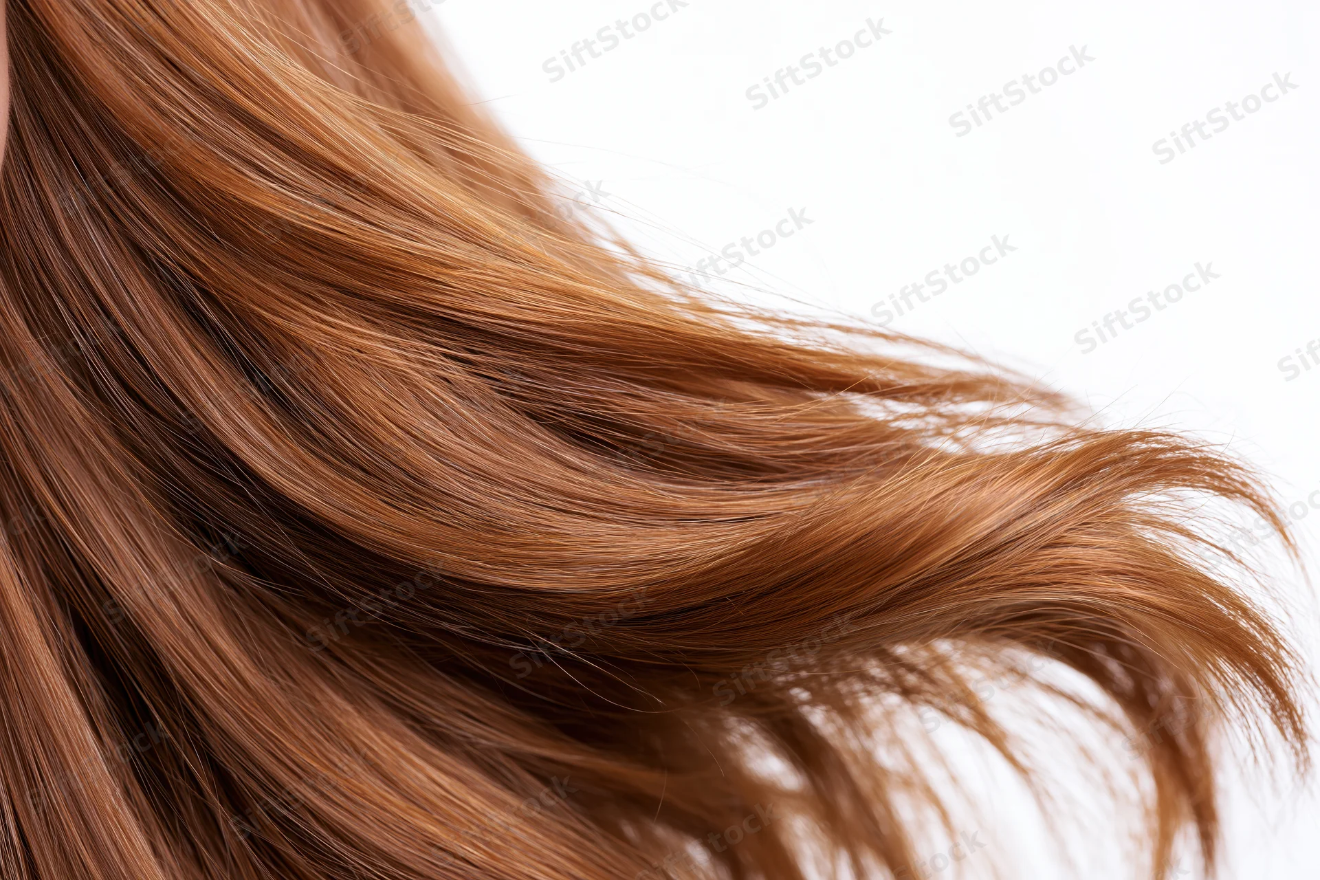 Flowing auburn-brown hair in motion against white background