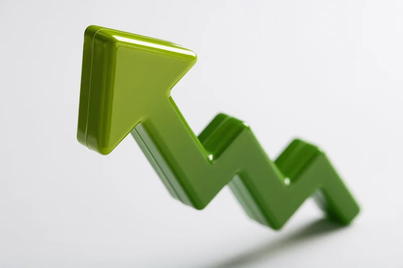 Glossy green 3d arrow pointing upward on white background