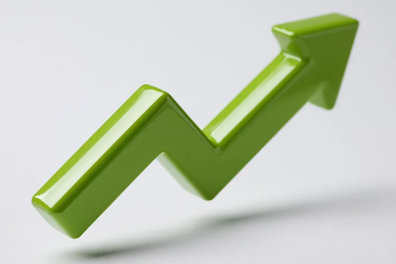 Glossy green 3d arrow pointing upward on white background