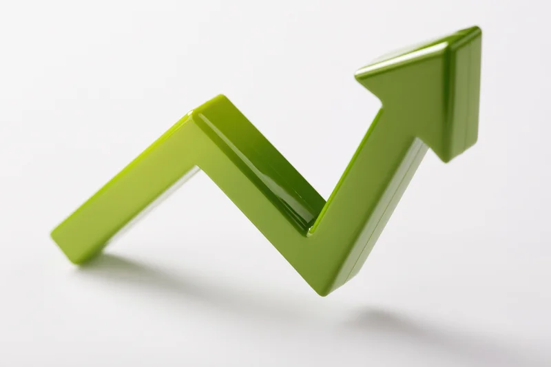 Glossy green 3d arrow pointing upward on white background