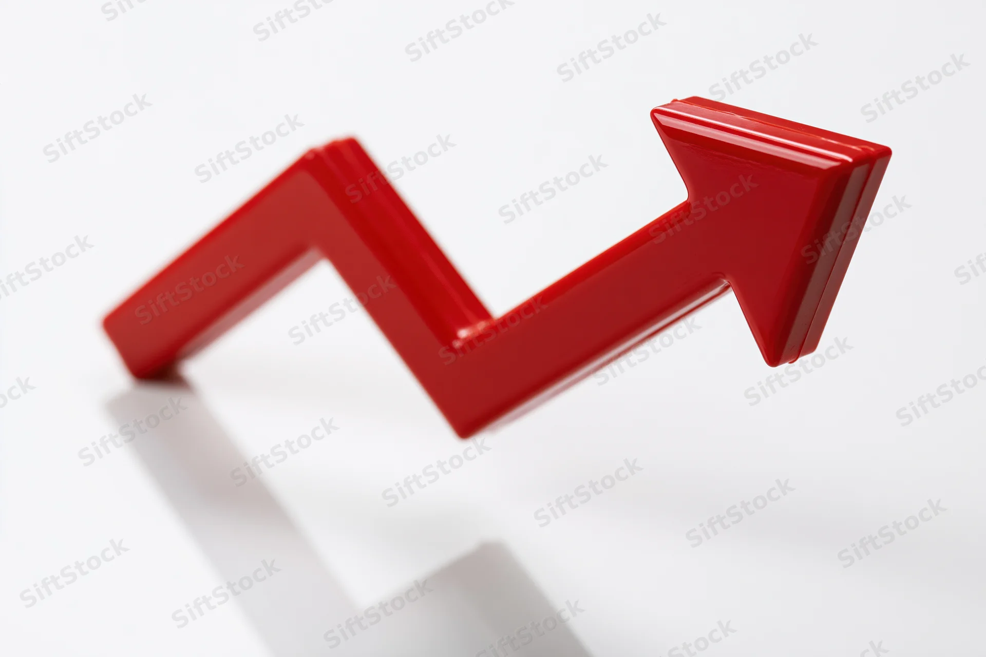 Glossy red three-dimensional arrow zigzagging upward on white background