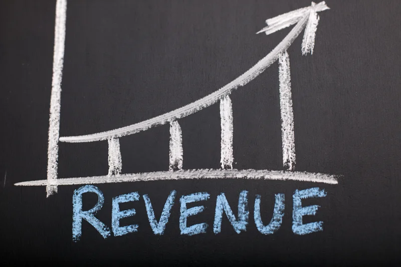 Upward trending revenue graph drawn in chalk on a blackboard