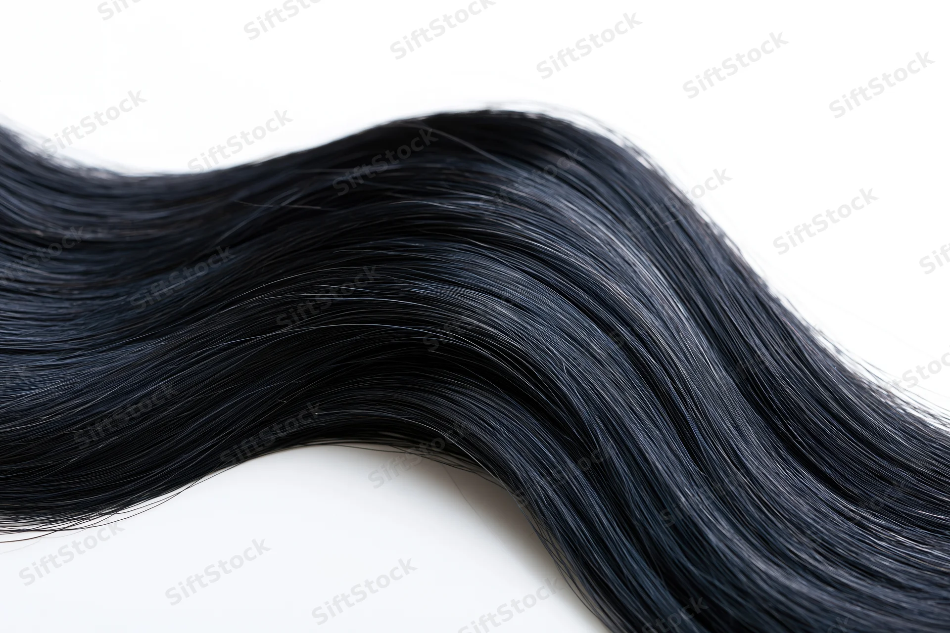 Flowing wave of dark black hair isolated on white background