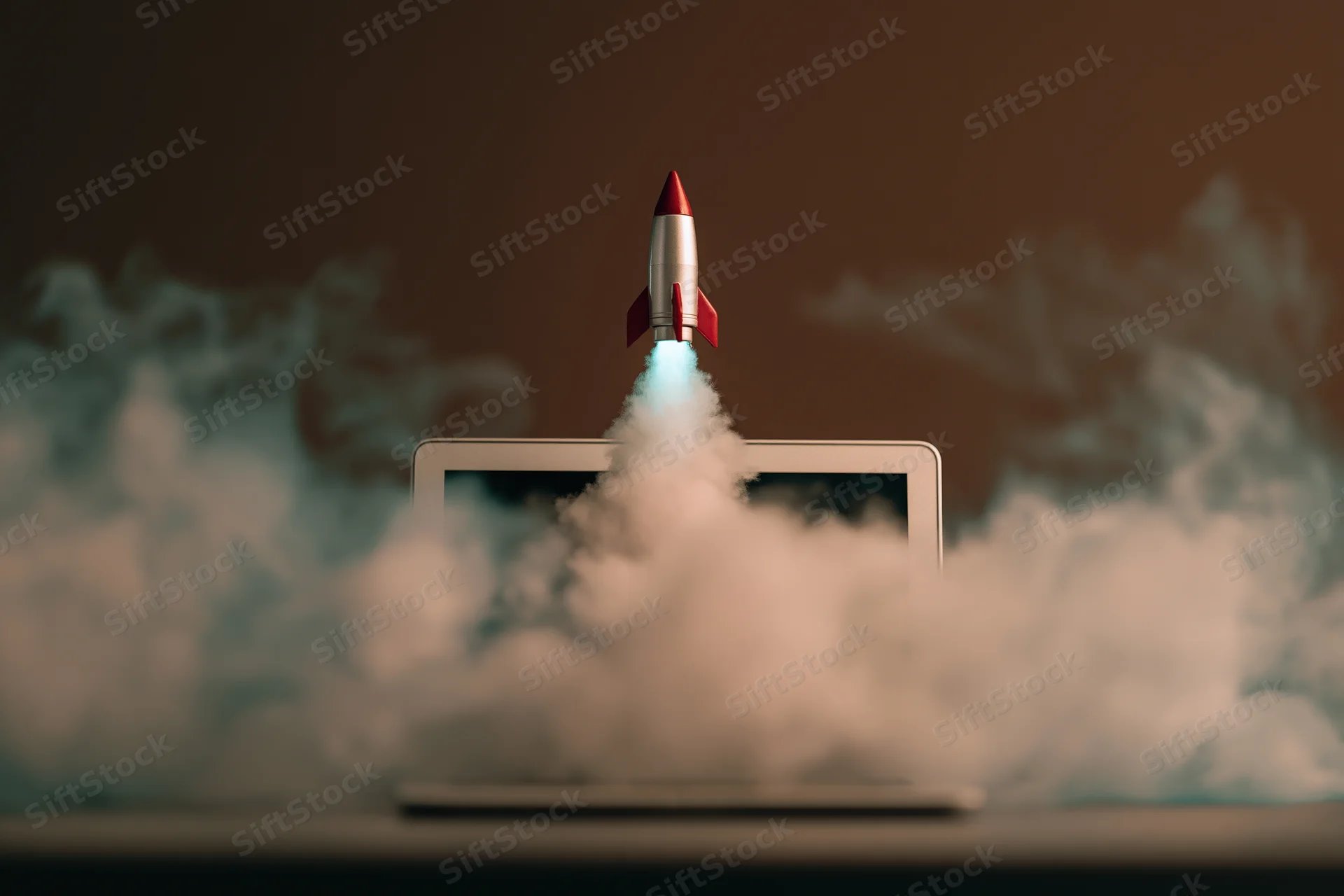 Small rocket launching from laptop screen surrounded by smoke