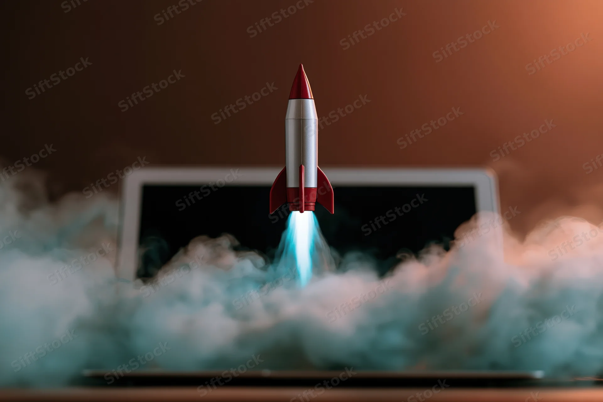 Small rocket launching from laptop screen surrounded by smoke and flames