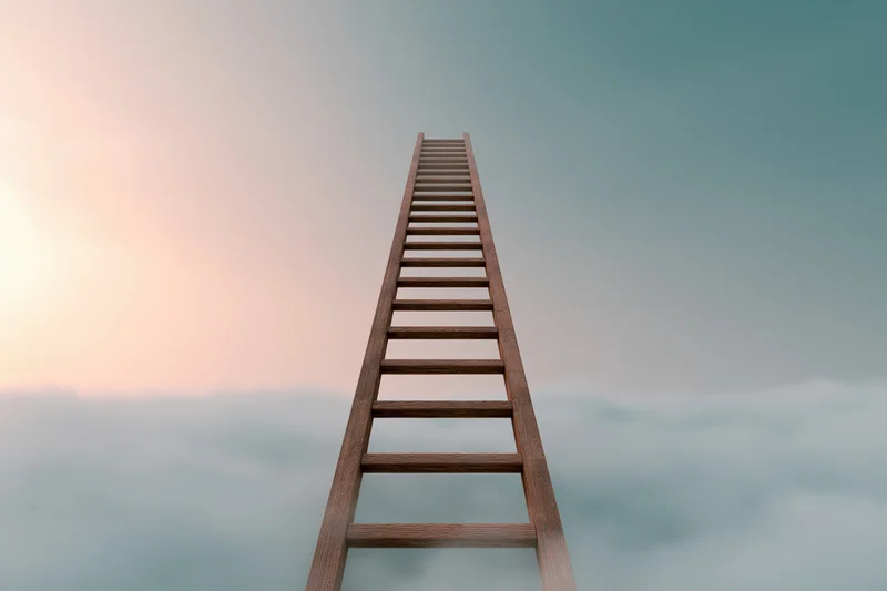 Wooden ladder rising vertically through soft clouds into the sky