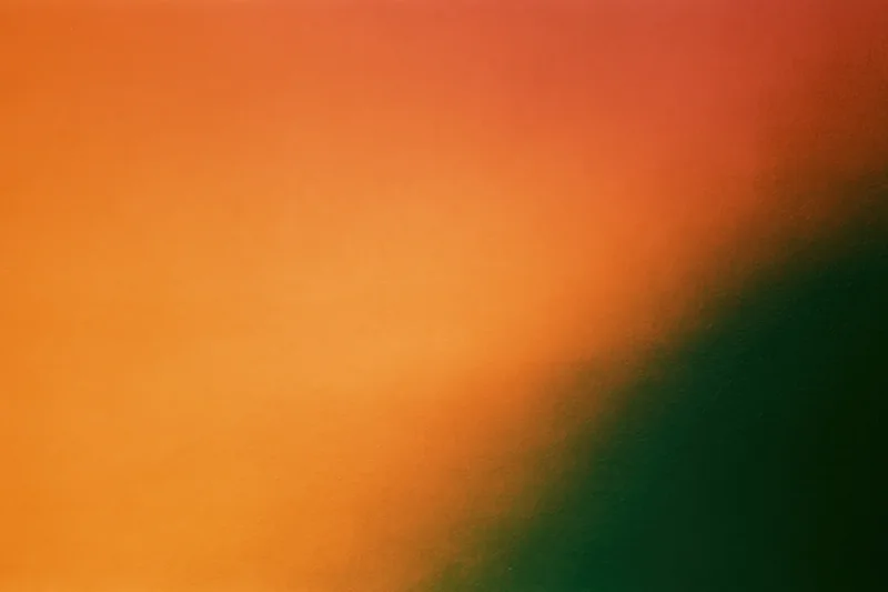 Abstract gradient background blending orange and green with grainy texture