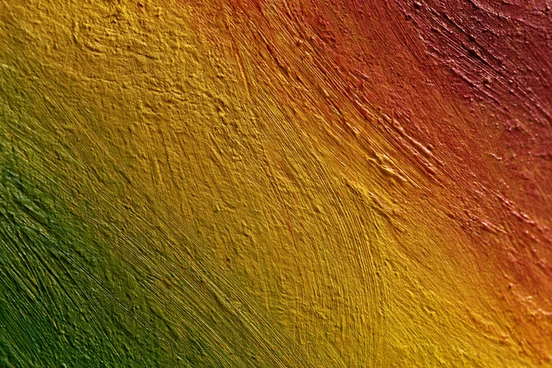 Abstract painted wall surface with diagonal brushstroke texture and warm color gradient
