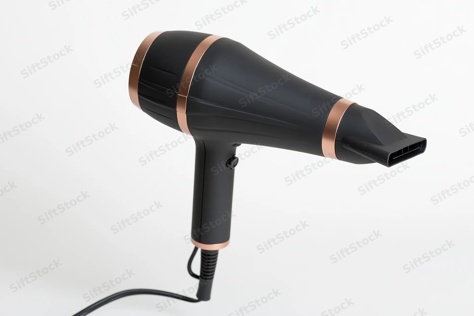 Black and rose-gold hair dryer with concentrator nozzle on white background