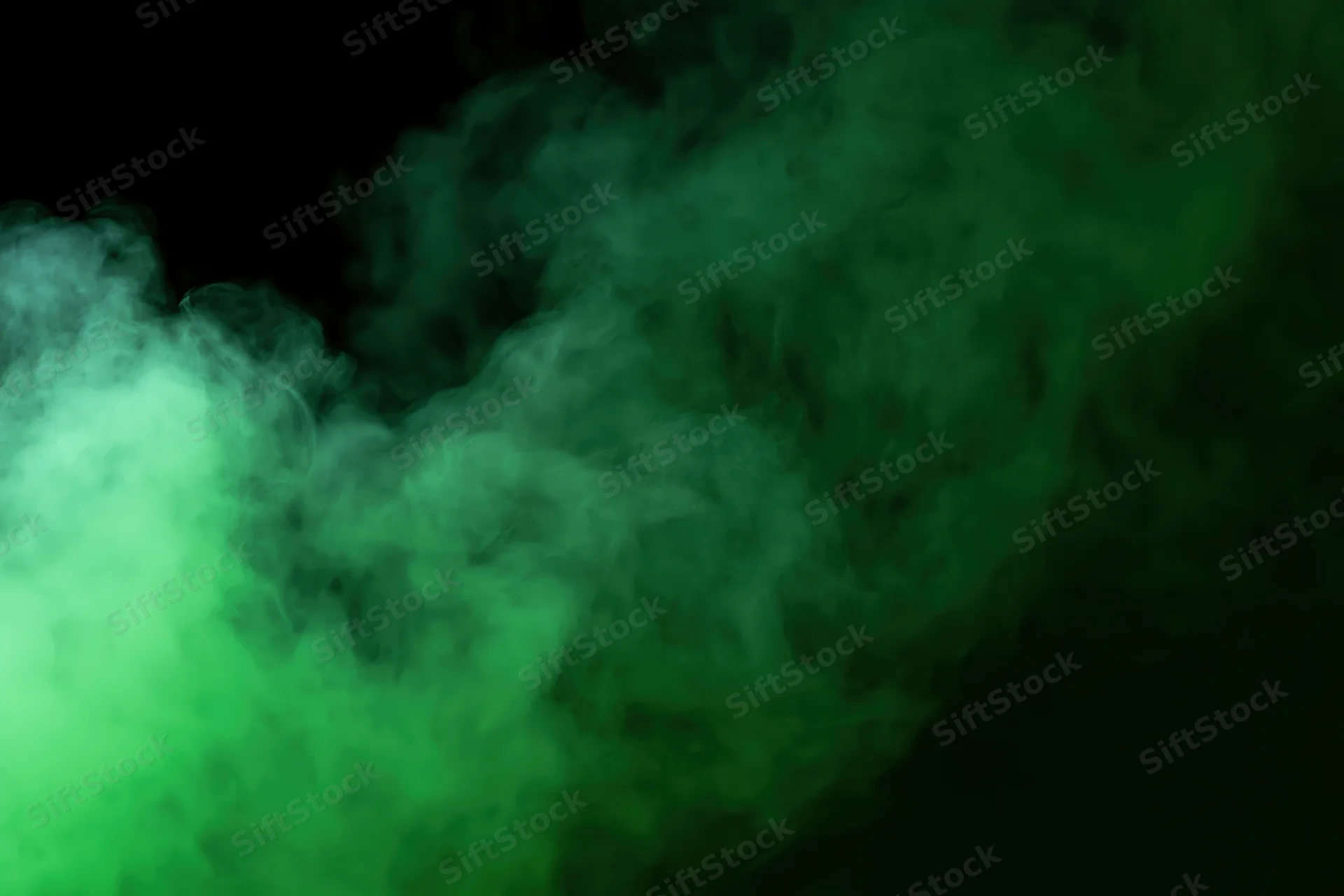 Green smoke drifting upward against a dark background